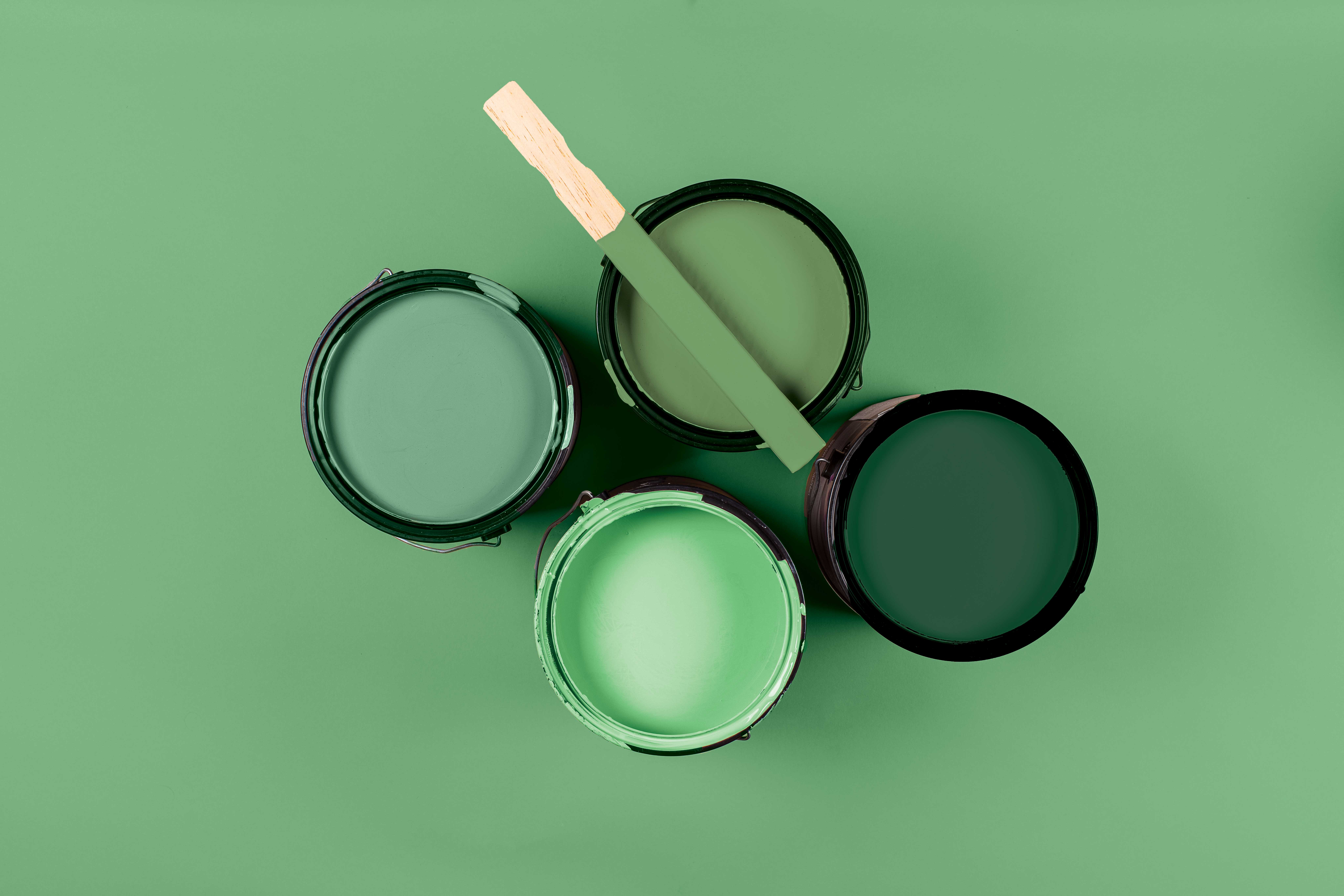 Four different shades of green wall paint from Hirschfields.