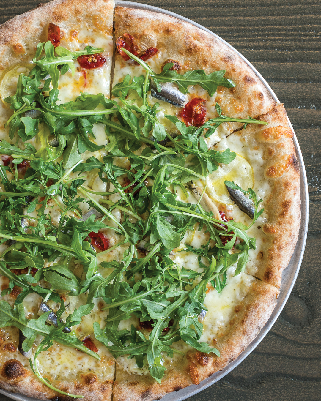 Kyndred Hearth’s Boquerones al Limon pizza features Spanish boquerones, lemon, goat cheese, Calabrian chili and arugula.