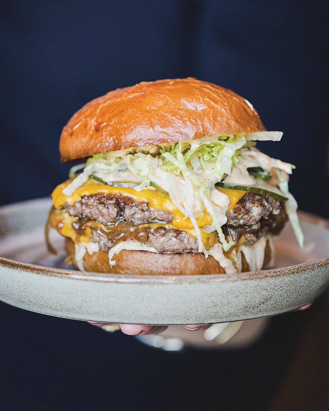 SKOL Burger with American cheese, caramelized onions and special sauce. Served with house-cut fries at Kyndred Hearth.
