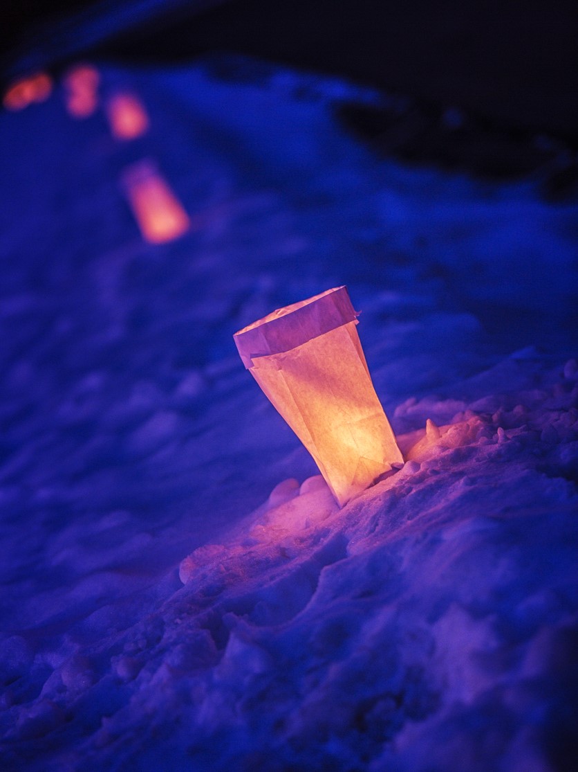 Paper bag lantern in the snow.