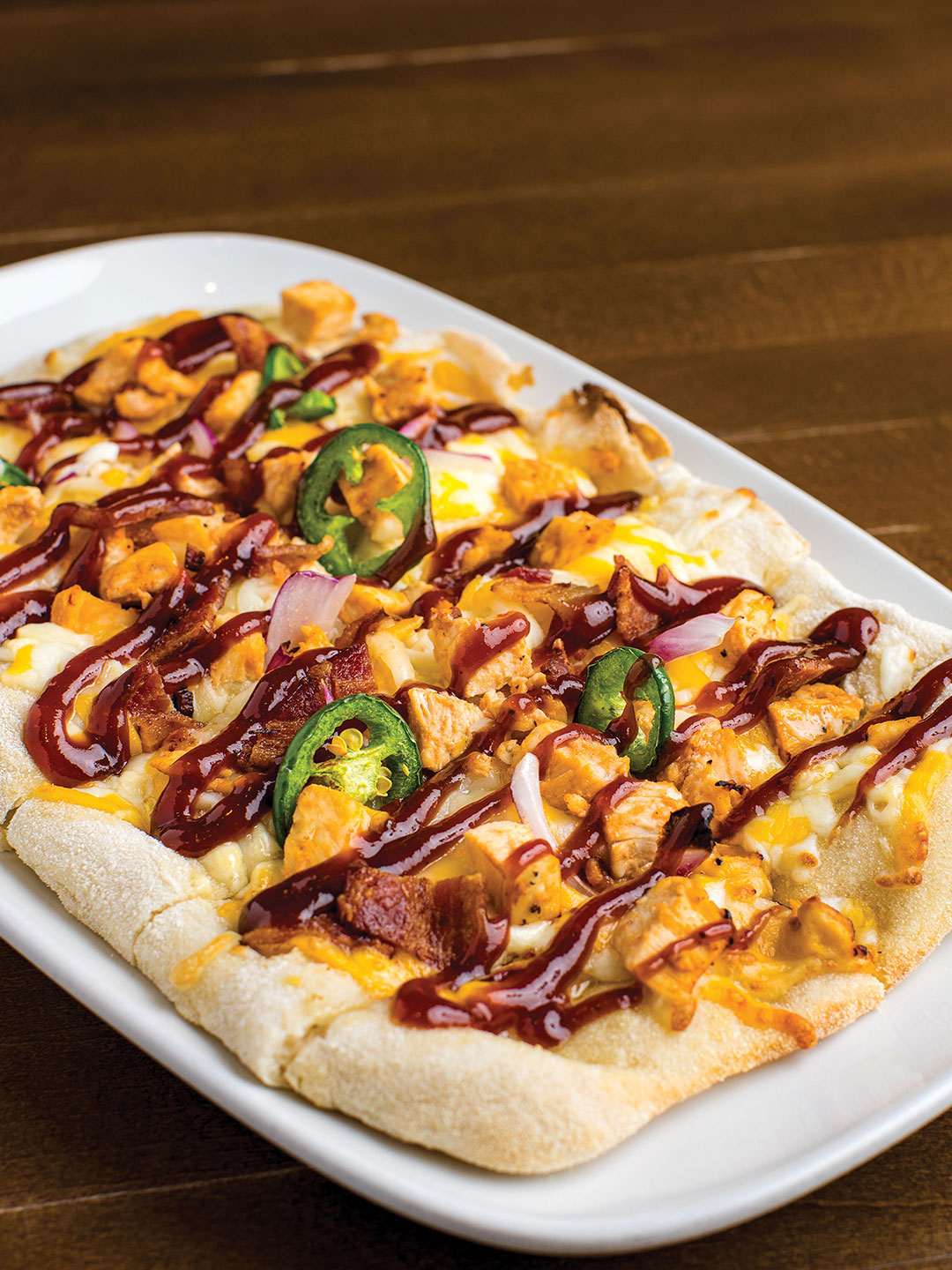 BBQ Chicken flatbread featuresCry Baby Craig’s aioli and chipotle BBQ chicken.