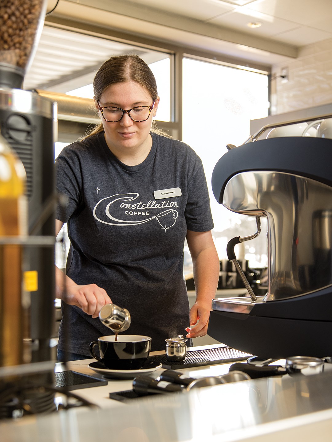 Lauren Ziehwein, who has worked at Constellation Coffee since it opened in July, makes a latte.