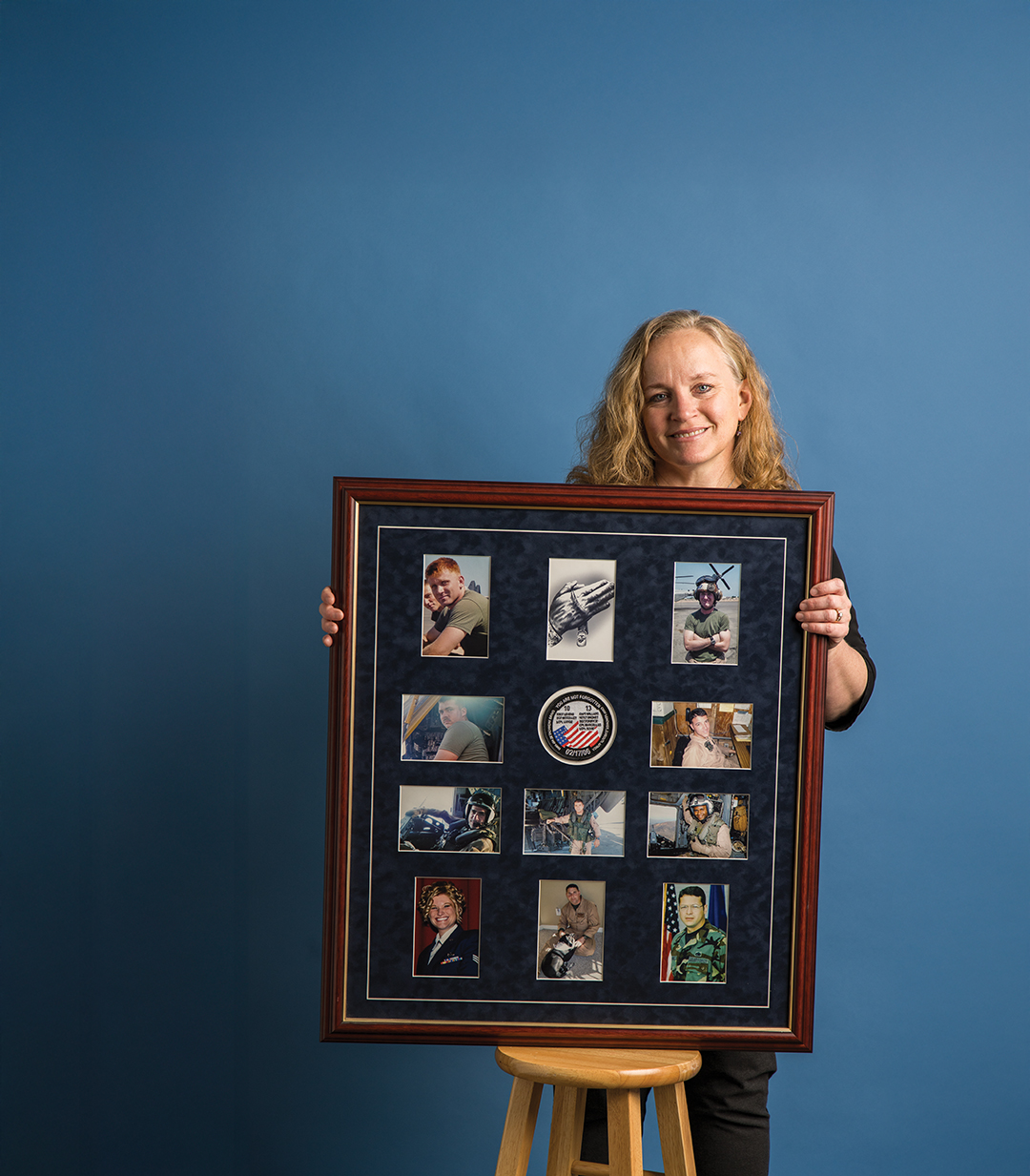 Susan Craig holds a framed picture of the colleagues who died in a helicopter crash in 2006: Capt. Bryan Willard, 1st Lt. Brandon Dronet, Staff Sgt. Donnie Levens, Sgt. James Fordyce, Sgt. Jonathan McColley, Cpl. Matthieu Marcellus, Lance Cpl. Samuel Large Jr., Lance Cpl. Nicholas Sovie, Staff Sgt. Luis Melendez Sanchez and Senior Airman Alecia Good.