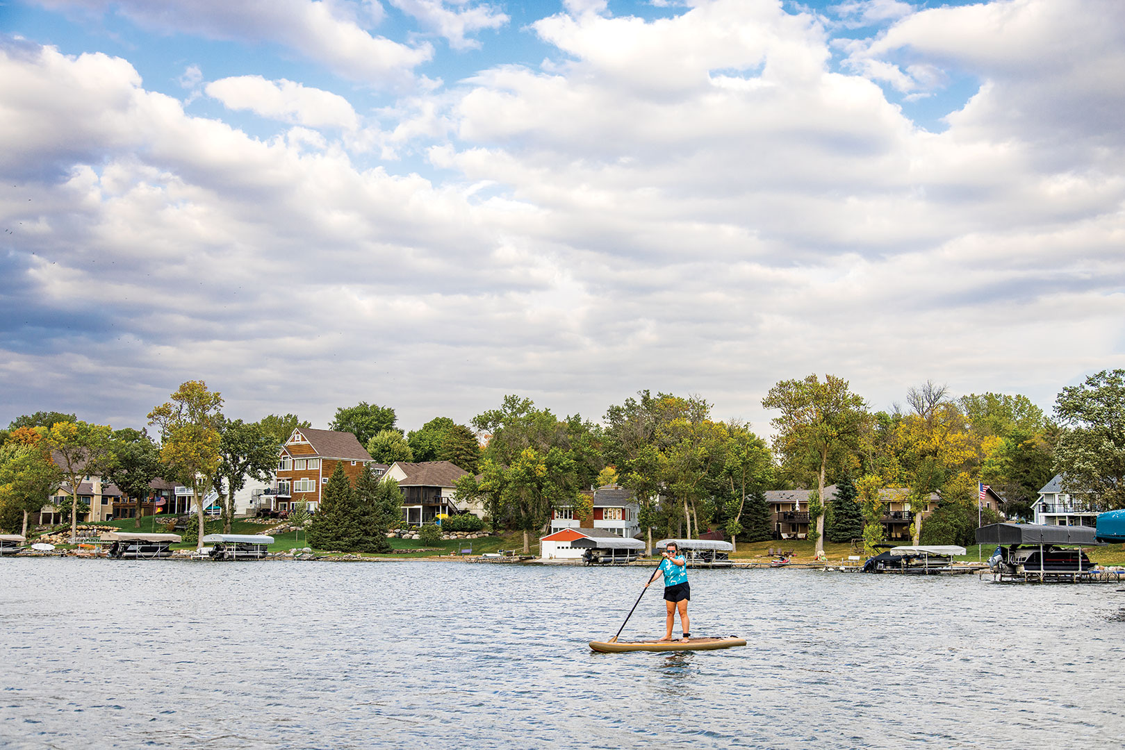 Jemma Killmer, owner of Minnesota Mermaid, paddleboarding on Prior Lake.