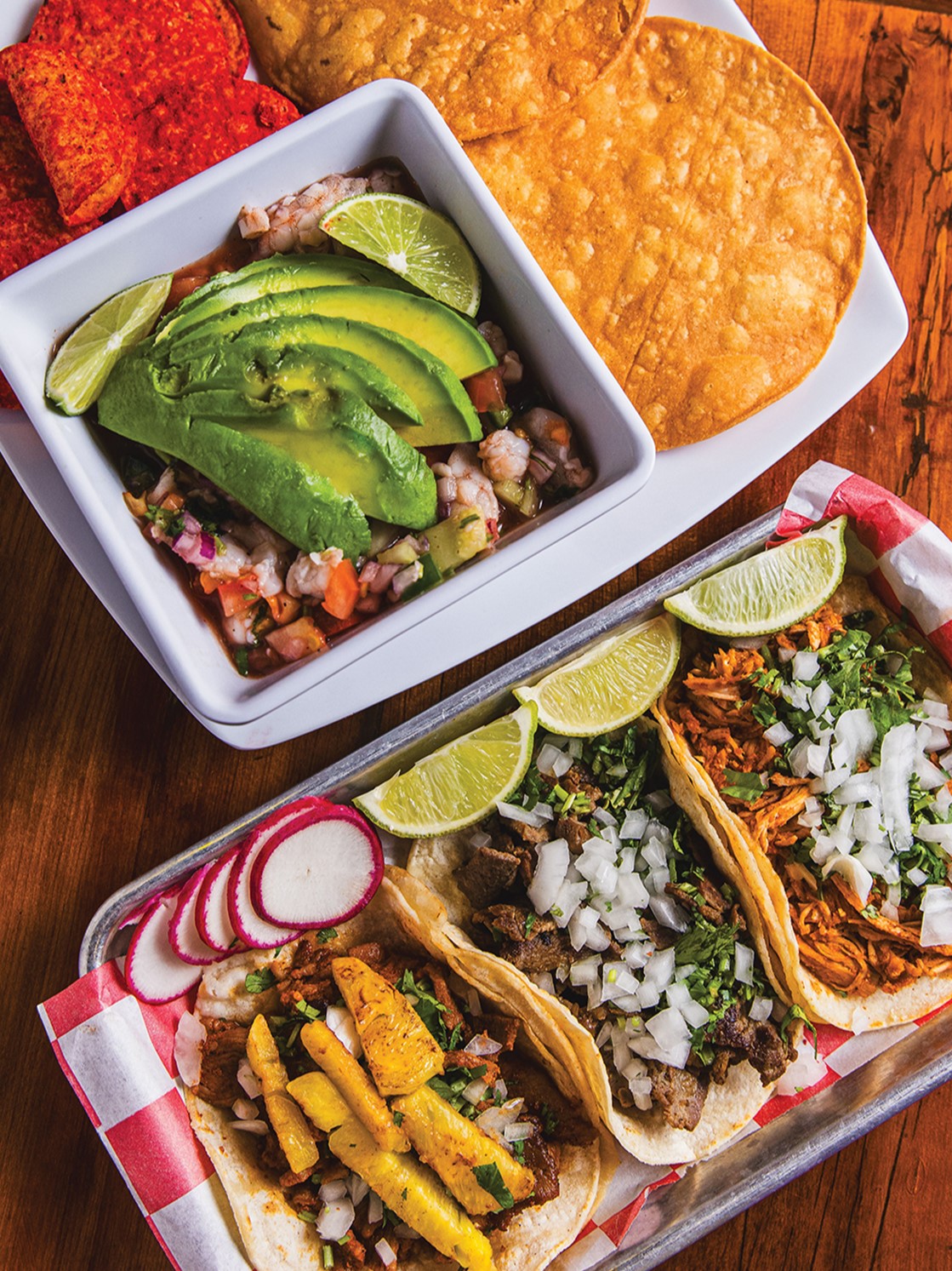 The al pastor (marinated pork), asada (grilled beef) and tinga de pollo (shredded chicken) tacos are some of the most popular menu items at Taqueria Los Compadres. The ceviche (top left) is also popular.