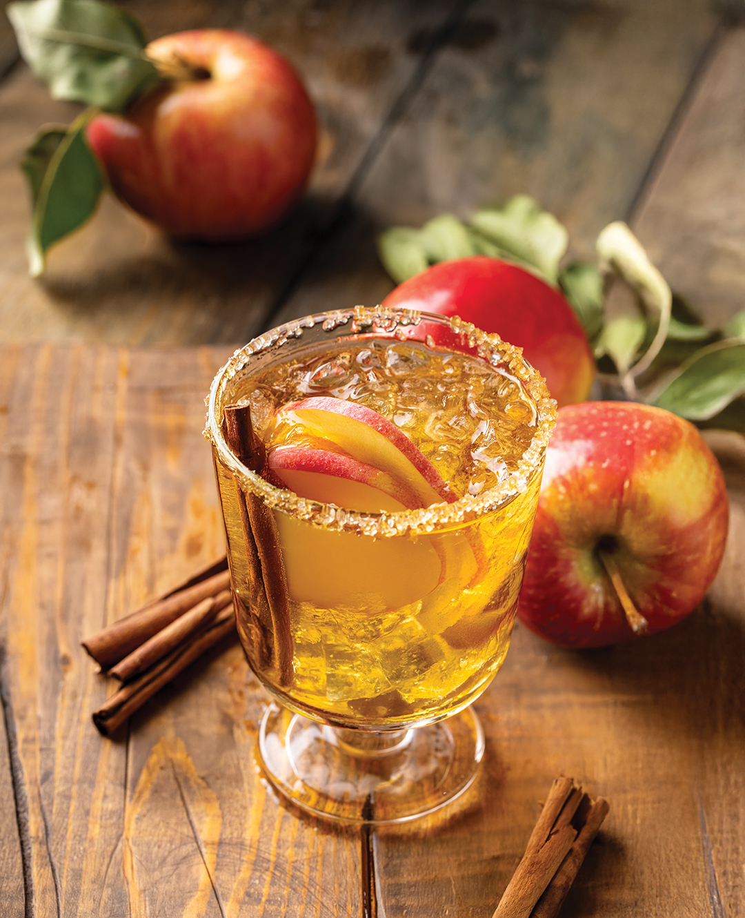 Festive fall cocktail or mocktail with hard cider, apple and orange with fall spices for Thanksgiving dinner